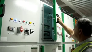 Electrical engineer opening the door of Switchgear