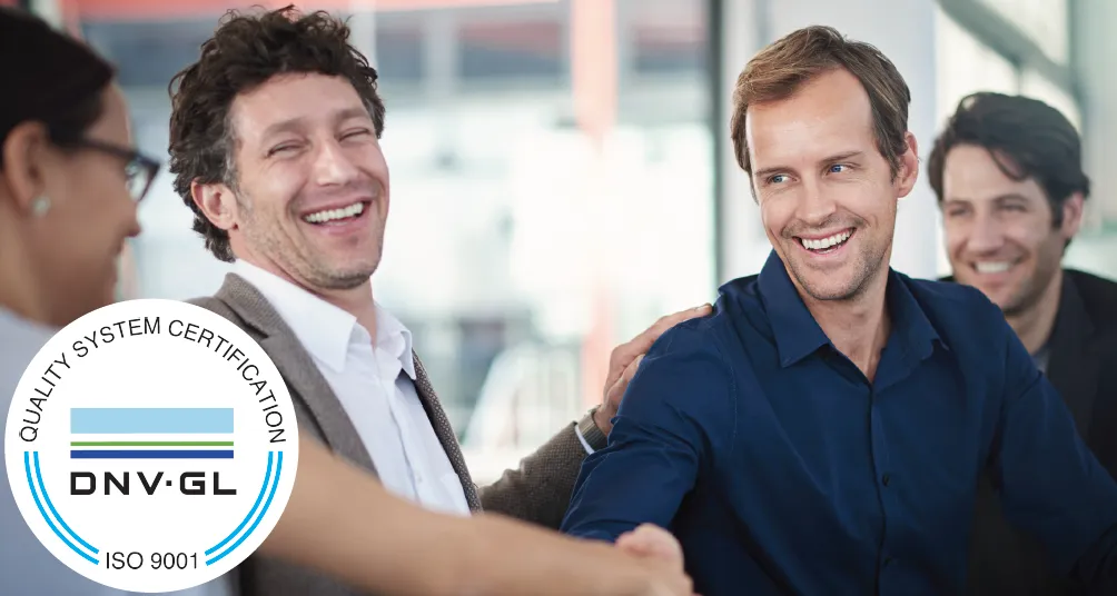 Workers shaking hands with quality management ISO 9001 mark overlaid