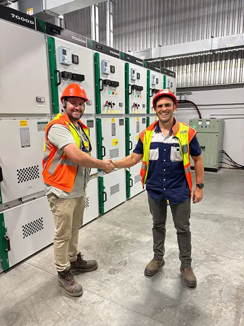 Andre's Electrical team TGOOD Africa standing in front of switchgear